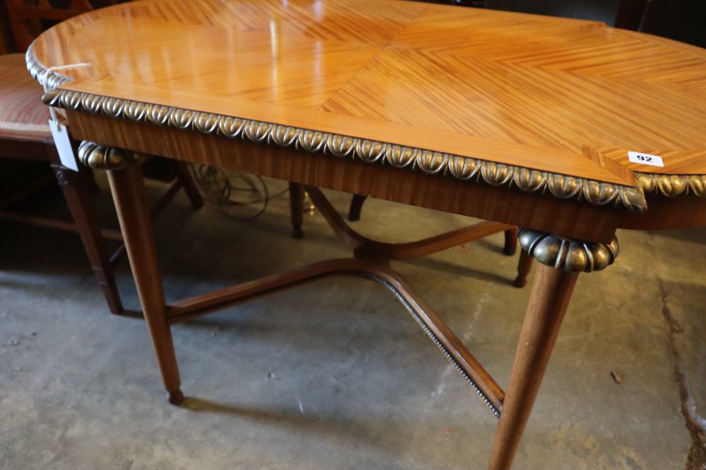 A parcel gilt satinwood centre table, width 113cm height 62cm, and a pair of Edwardian satinwood salon chairs